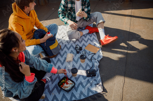 Smiling friends talking during lunch on roof