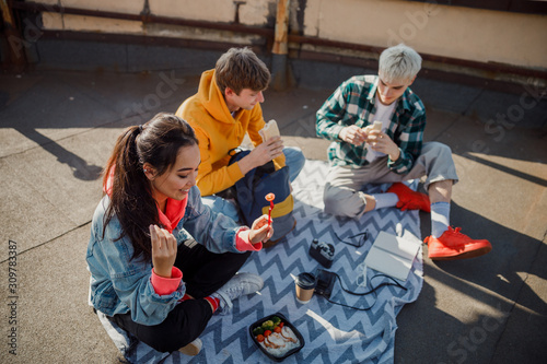 Happy friends is holding food on roof