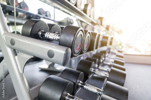 Abstract blurred gym equipment and fitness room interior for background