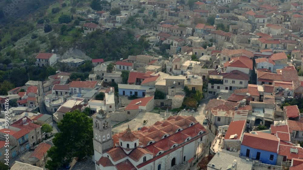 Aerial view of old village Pano Lefkara with church and many houses with orange roofs in mountains, Cyprus Island. Drone footage Aerial view of old village Pano Lefkara with church and many houses with orange roofs in mountains, Cyprus Island. Drone footage