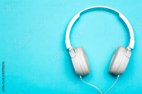 Musical headphones on a colored blue background. Aesthetics retro 80s and minimal concept