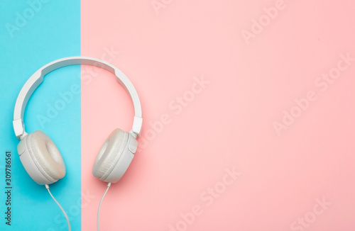 Musical headphones on a colored blue and pink background. Aesthetics retro 80s and minimal concept