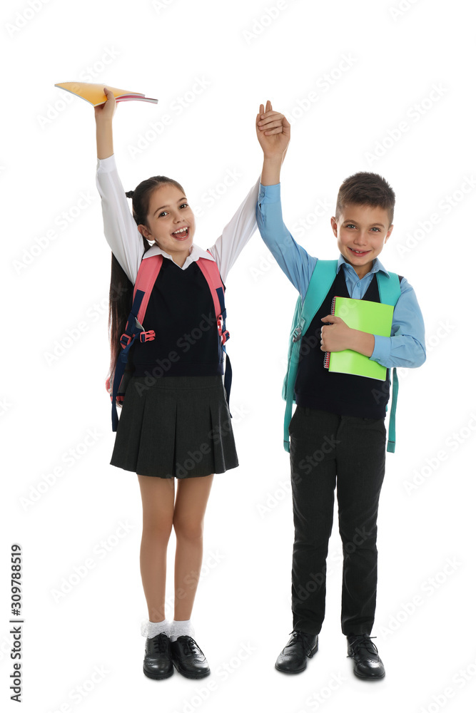 Happy children with school stationery on white background Happy children with school stationery on white background