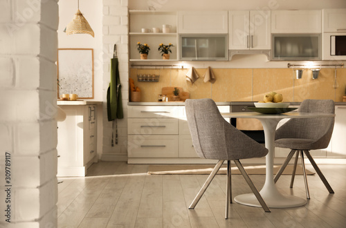 Modern kitchen interior with stylish white furniture. Space for text