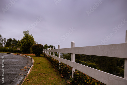 Paisagem na região de Campos do Jordão, Serra da Mantiqueira, São Paulo, Brasil, em dia nublado e chuvoso, com cerca branca e vegetação típica da região. photo