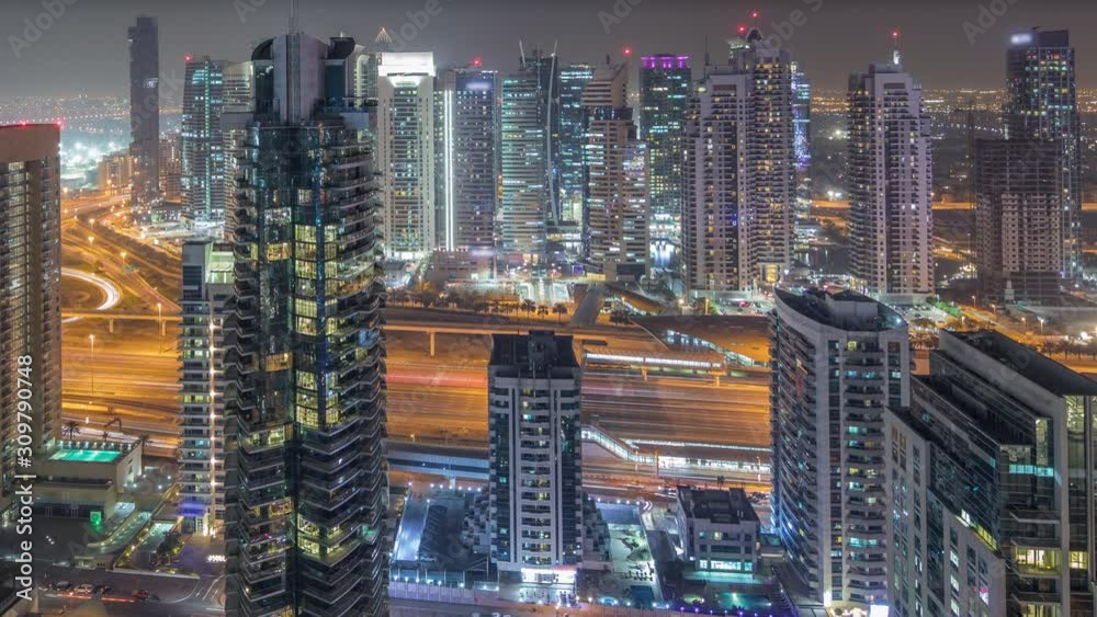 Aerial top view of Dubai Marina night timelapse. Skyscrapers in Dubai, UAE. Illuminated modern towers and traffic on the road Aerial top view of Dubai Marina night timelapse. Skyscrapers in Dubai, UAE. Illuminated modern towers and traffic on the road