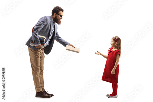 Male teacher giving a book to a girl