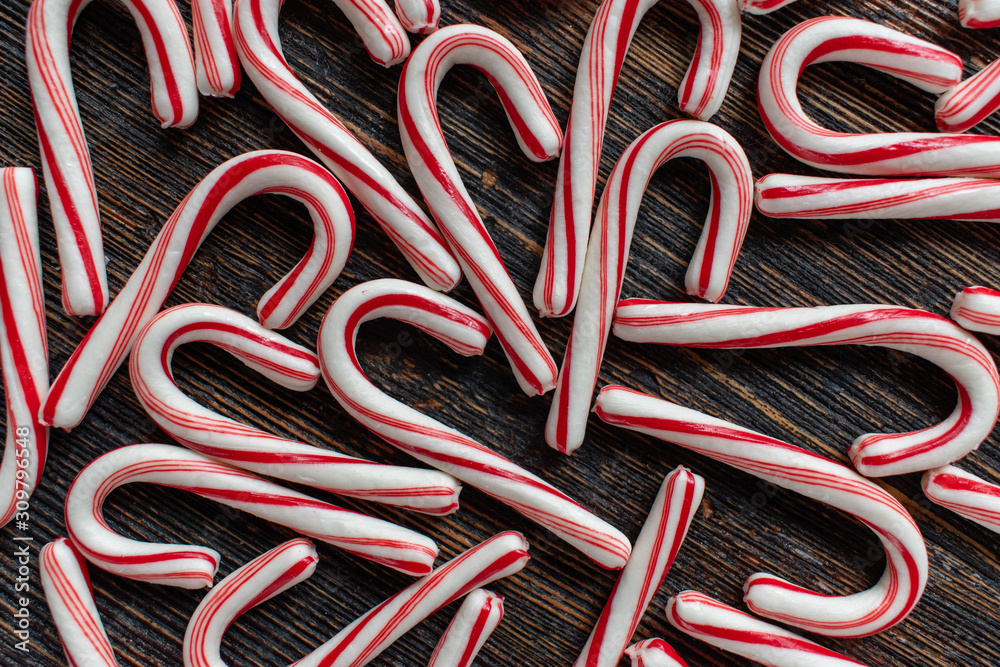 design group of candy canes on rustic wood table flat lay