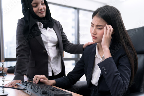 Muslim female employee supports her colleagues after working hard all day. photo