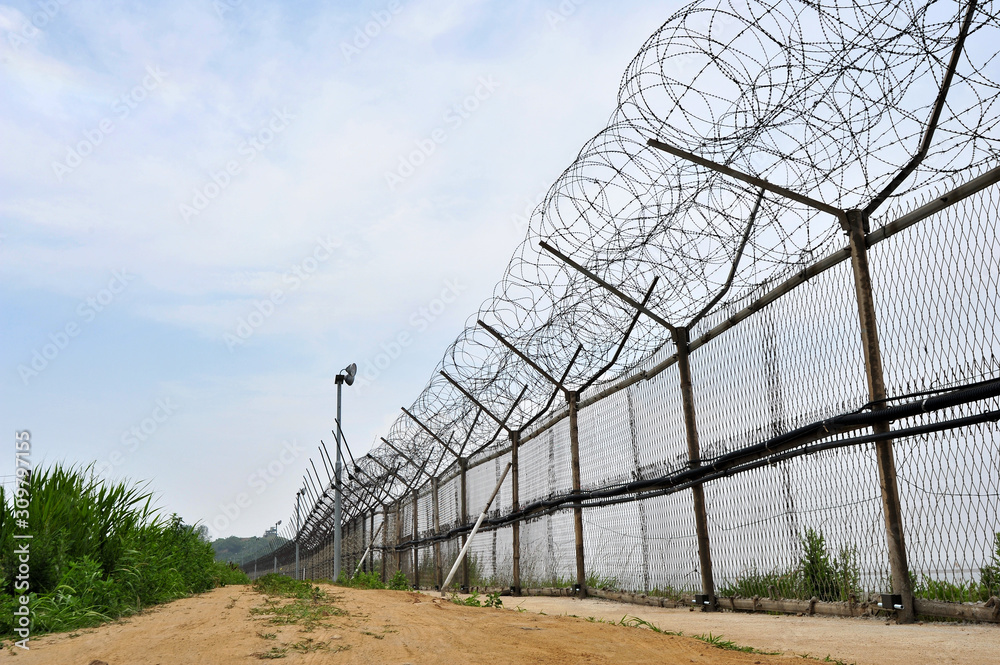 Barbed wire fence installed along the shore