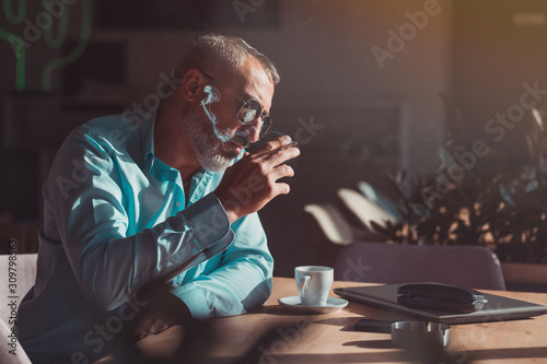 Man drinking first morning coffee and smoking on his job break. Business people
