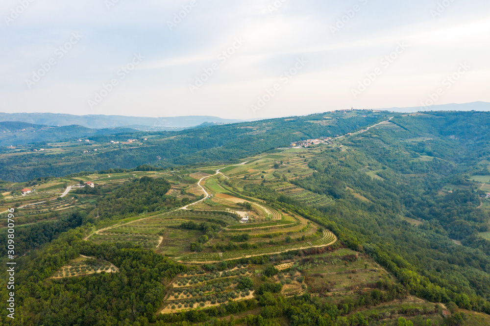 Perspective image of a narrow road running down a mountainside in a mountainous area. The view from the top. Shooting from a drone. Perspective image of a narrow road running down a mountainside in a mountainous area. The view from the top. Shooting from a drone.