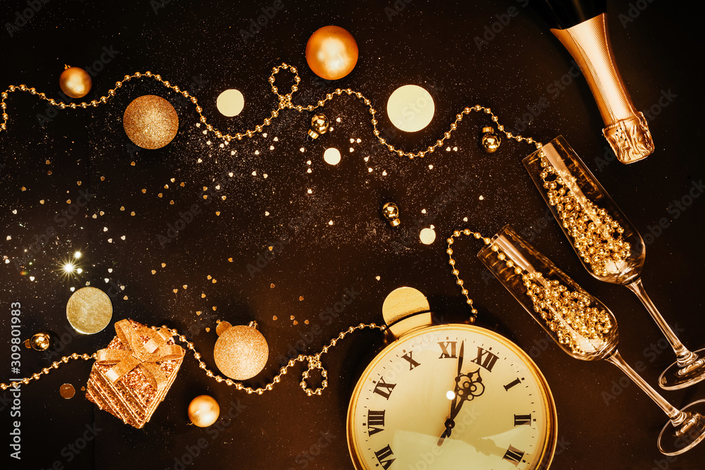 Christmas dark background. Golden Christmas items and decorations, glasses, champagne, watches. Christmas celebration concept. Flat lay top view composition