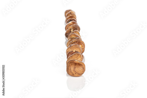 Lot of whole tasty brown hazelnut in row isolated on white background