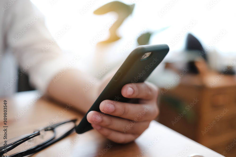 Close up hands asia businessman looking at smartphone looking at smartphone and having a coffee in a pub. Close up hands asia businessman looking at smartphone looking at smartphone and having a coffee in a pub.