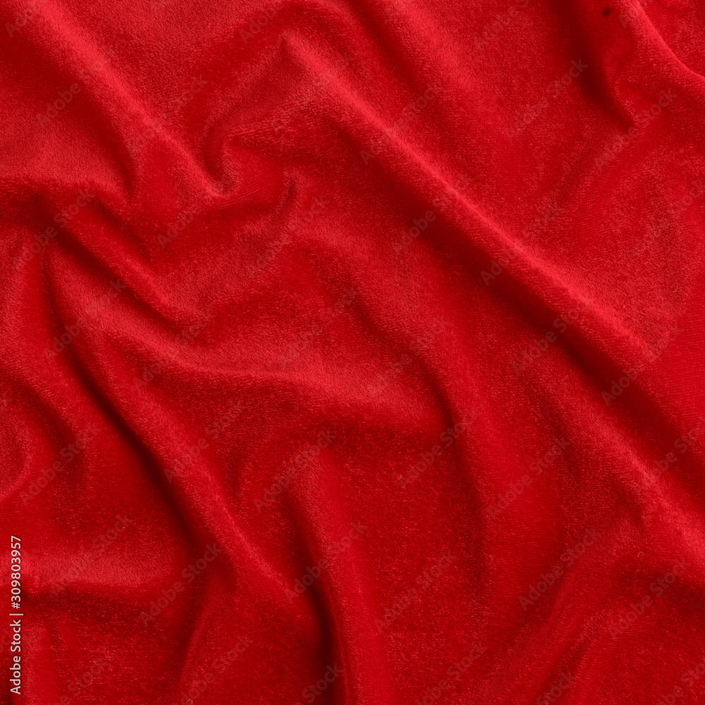 Wavy red silk, atlas or veil fabric, crumpled with creases, bended in spiral wrinkle Wavy red silk, atlas or veil fabric, crumpled with creases, bended in spiral wrinkle