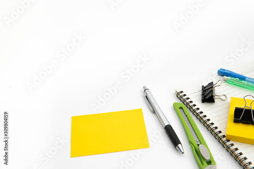 post it note, pen, cutter, note pad and clipper in isolate white background with space for text. office stationary equipment concept.