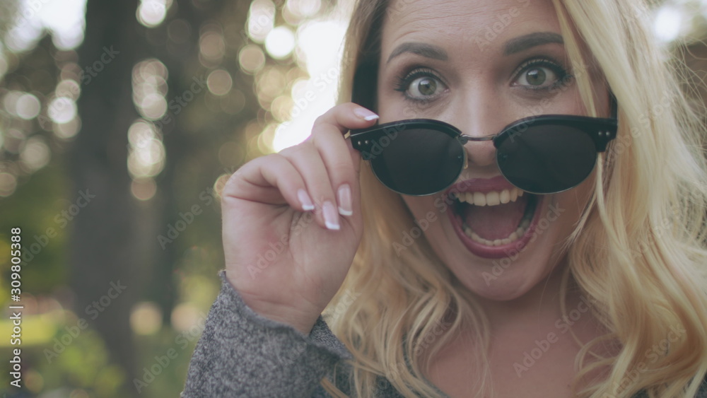 Attractive Blonde Woman Smile Sunglasses Look. Young Caucasian Girl Laugh Summertime Nature Scenery Background. Happy Adult Enjoy Wear Black Spectacles Free Time Activity Attractive Blonde Woman Smile Sunglasses Look. Young Caucasian Girl Laugh Summertime Nature Scenery Background. Happy Adult Enjoy Wear Black Spectacles Free Time Activity