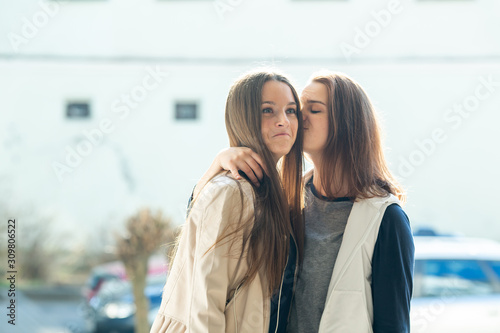Wallpaper Mural Bisexual relationship lesbian young caucasian teenage girls on the street in summer day. Lesbian couple love story. LGBT community. Torontodigital.ca