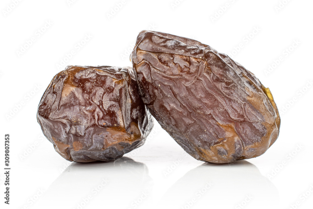 Group of two whole dried brown date fruit isolated on white background Group of two whole dried brown date fruit isolated on white background