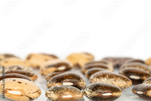 Lot of whole tasty speckled brown bean pinto isolated on white background