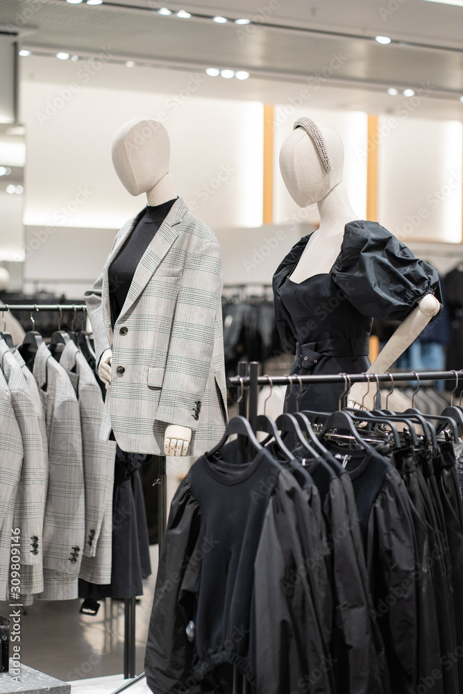 The interior of a fashion store of women's clothing of a famous brand. Mass market. Brand clothes. All things are laid out neatly on the shelves in the closet. Wardrobe order. The interior of a fashion store of women's clothing of a famous brand. Mass market. Brand clothes. All things are laid out neatly on the shelves in the closet. Wardrobe order.