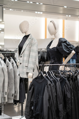 The interior of a fashion store of women's clothing of a famous brand. Mass market. Brand clothes. All things are laid out neatly on the shelves in the closet. Wardrobe order.