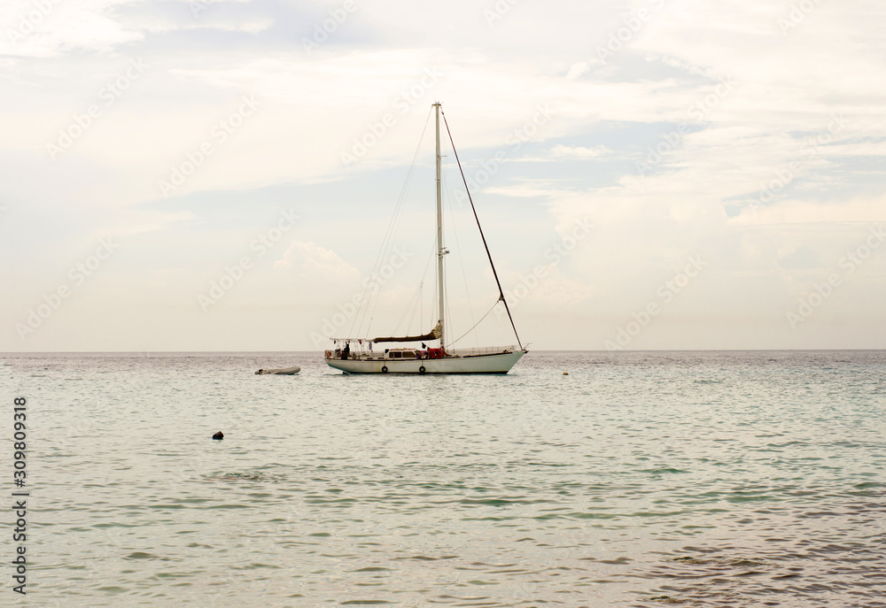 Sailboat in the ocean near Curacao with a cloudy sky