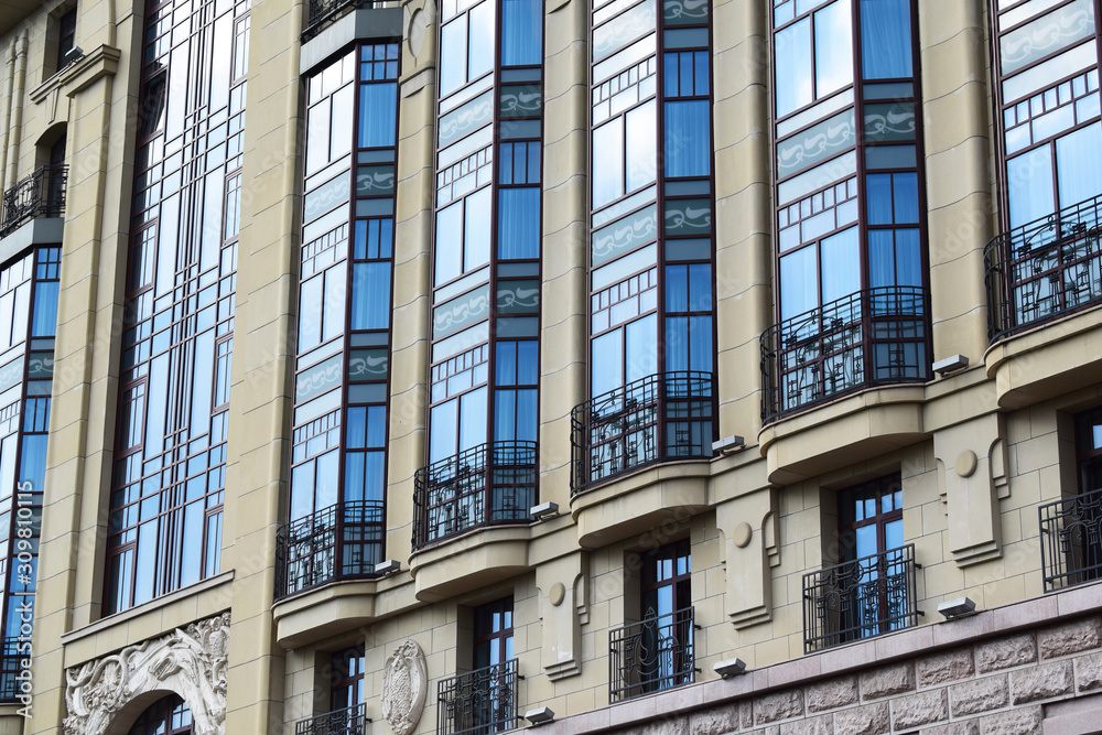 facade of a beige high-rise building with balconies facade of a beige high-rise building with balconies