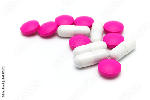 Prescription drugs, pills, capsules and tablets of different colors all mixed in. On white background.