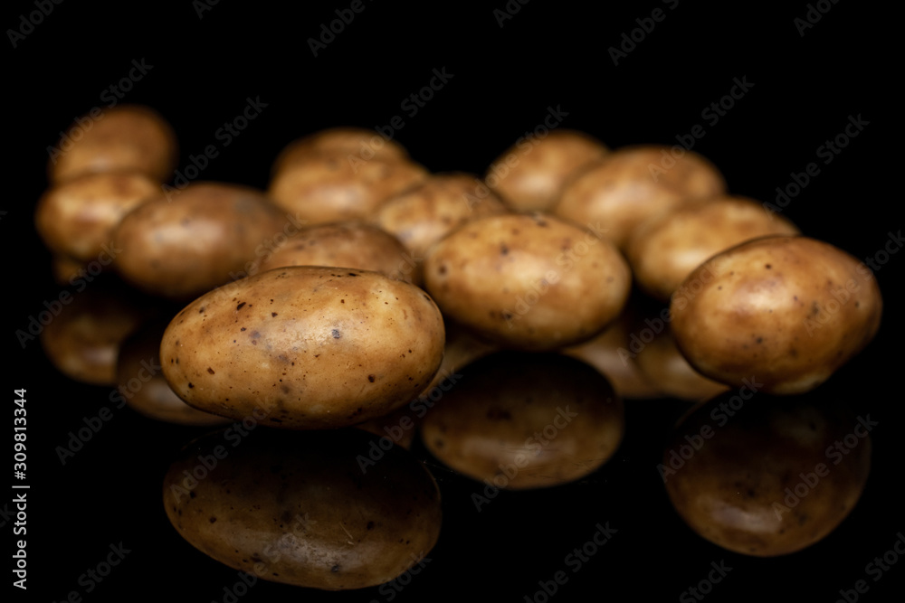 Lot of whole tiramisu brown almond nut isolated on black glass Lot of whole tiramisu brown almond nut isolated on black glass