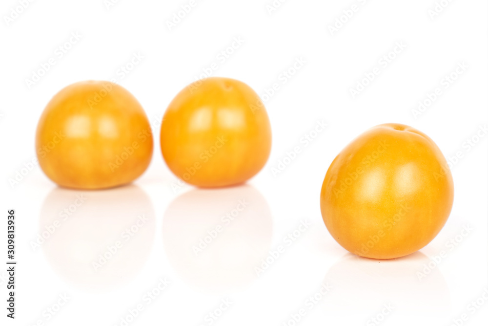 Group of three whole bright fresh orange physalis isolated on white background