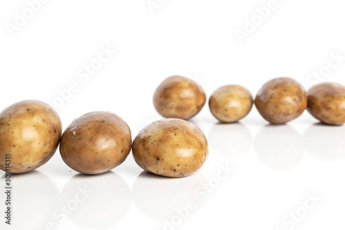 Group of seven whole tiramisu brown almond nut isolated on white background