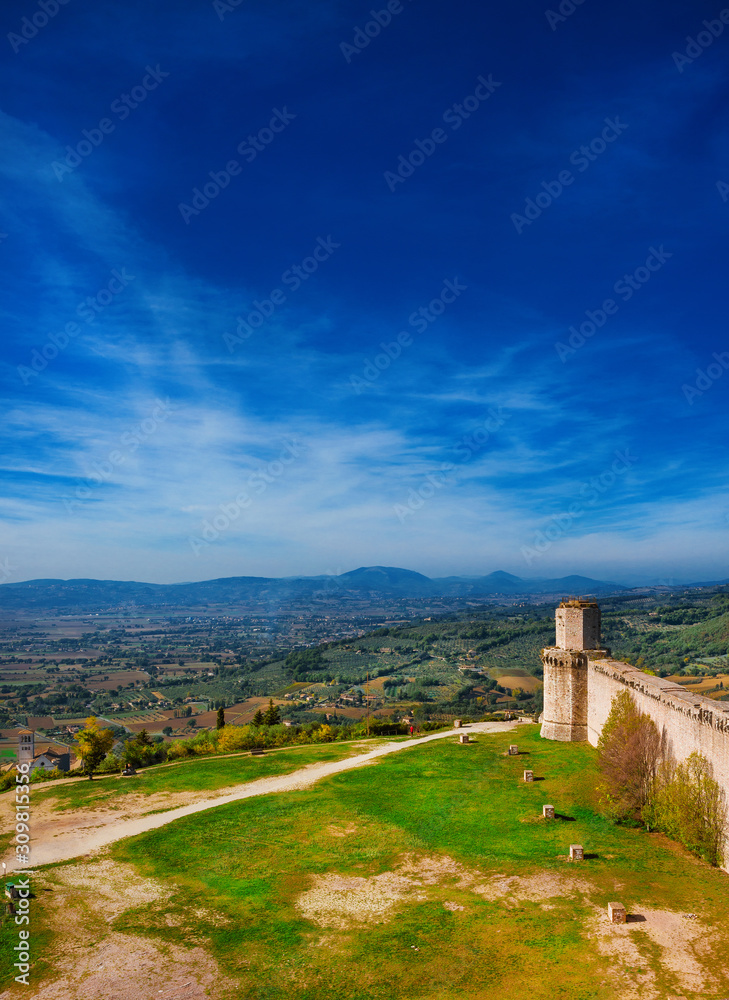View of Umbria countryside and St Francis Basilica from Assisi ancient walls (with copy space)
