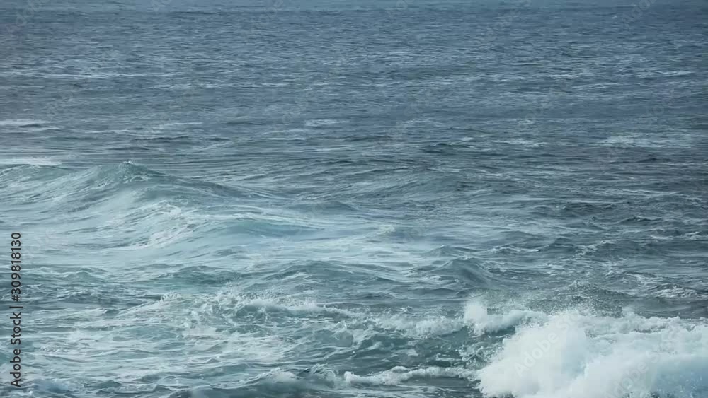 Big splashing ocean wave rushes towards the coast of an exotic island in the sunny Pacific. Big splashing ocean wave rushes towards the coast of an exotic island in the sunny Pacific.