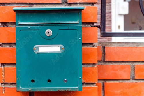 A beautiful mailbox hangs waiting for newspapers, parcels and letters.