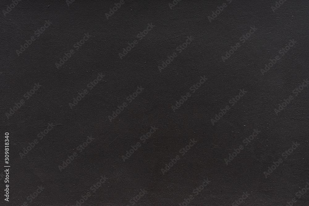 Plain black stucco background. The texture of the dark wall.