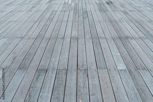 The texture of the flooring from wooden boards. Background of a street scene from wooden planks. Wooden deck. Plank floor perspective podium.