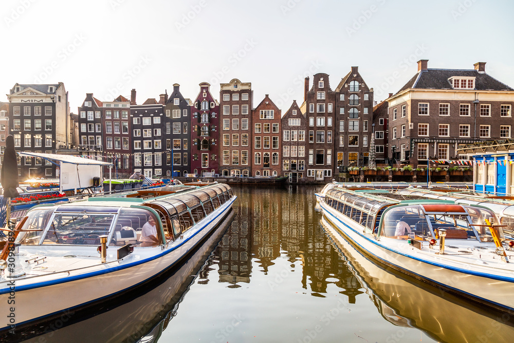 Amsterdam boats on the canal in Damrak area