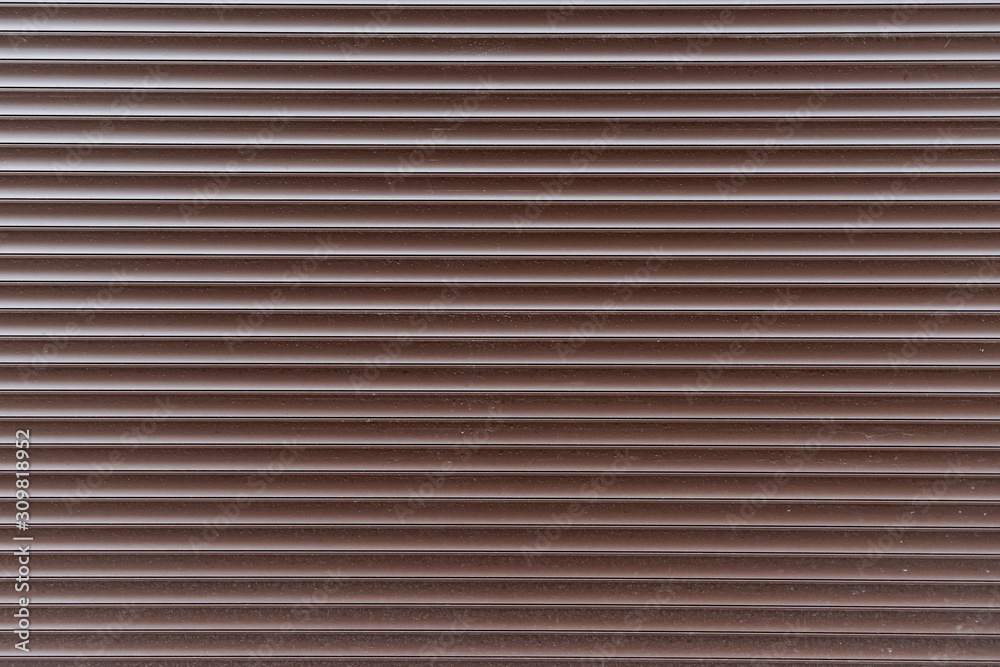 Brown horizontal blinds texture. Background of metal rolling shutters. Brown horizontal blinds texture. Background of metal rolling shutters.