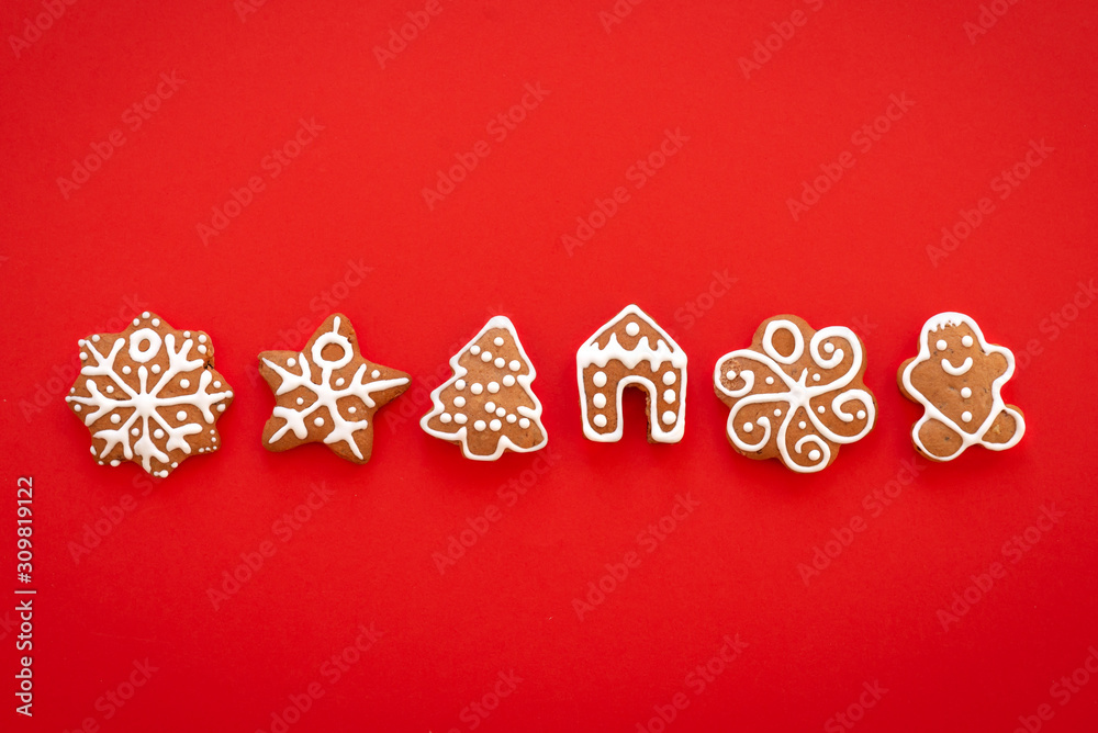 Xmas gingerbread cookies on the red background. Christmas, New Year, winter concept. Christmas sweet composition. Flat lay, top view, copy space Xmas gingerbread cookies on the red background. Christmas, New Year, winter concept. Christmas sweet composition. Flat lay, top view, copy space