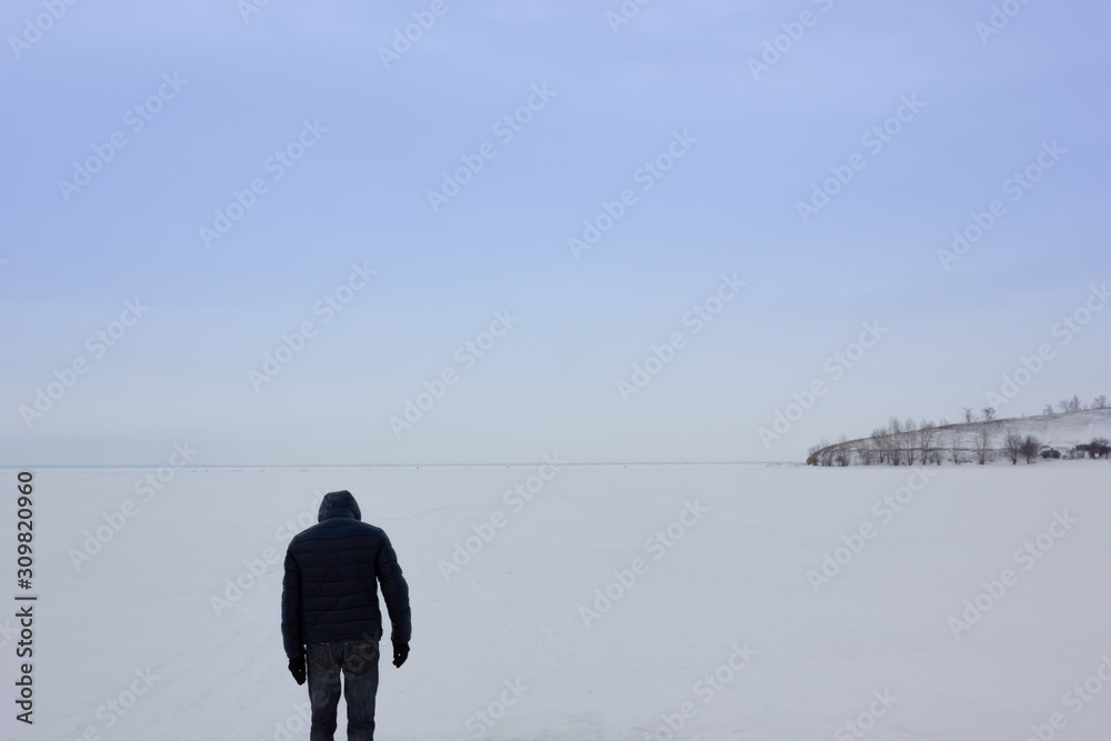 Winter snowy landscape with plain and man