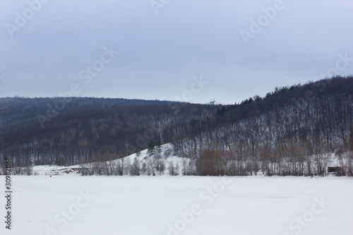 Winter snowy landscape with hills and trees © YelliJelli