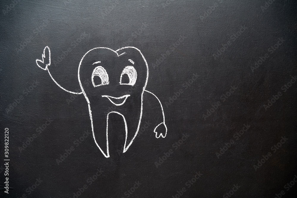 doodle tooth with smile drawing on blackboard