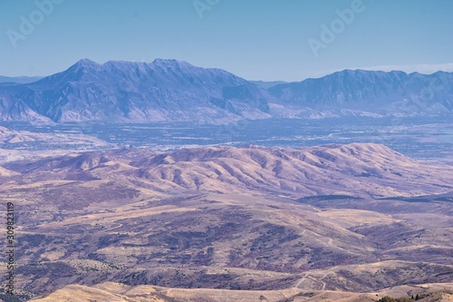 Wasatch Front Rocky Mountain landscapes from Oquirrh range looking at Utah Lake during fall. Panorama views near Provo, Timpanogos, Lone and Twin Peaks. Salt Lake City. United States.