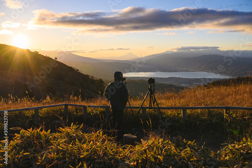 Outdoors photographer photographs Mt.Fuji in morning