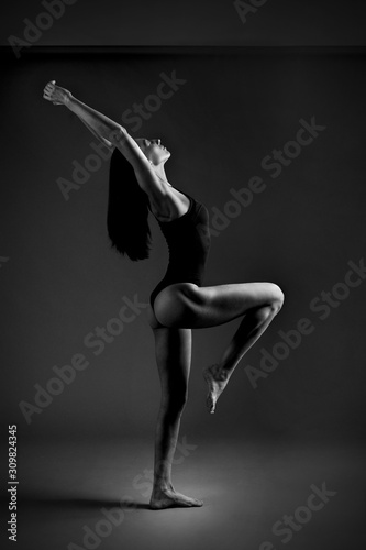 theatrically photo with oriental exterior slim girl shows yoga poses