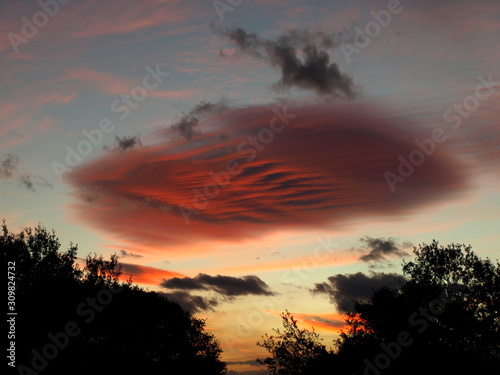 Nice cloud of reddish tones over a blue sky at sunset