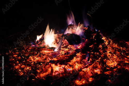 A low light long exposure photo of smouldering coals.