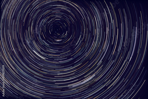 star trails - light streaks of stars around Polaris in the night sky due to Earth's rotation